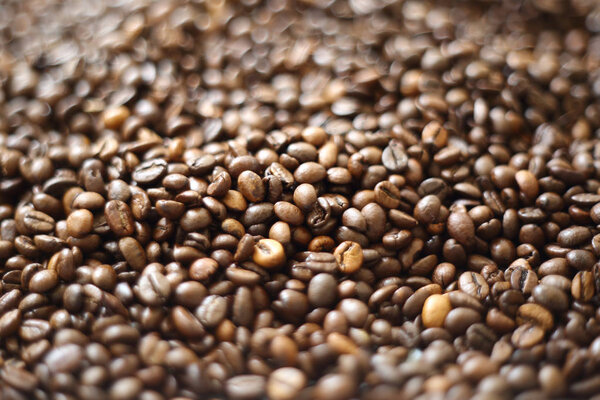 Coffee beans blur testured background. Defocus (or selected focus) coffee texture.