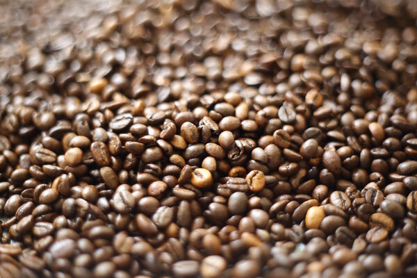 Coffee beans blur testured background. Defocus (or selected focus) coffee texture.