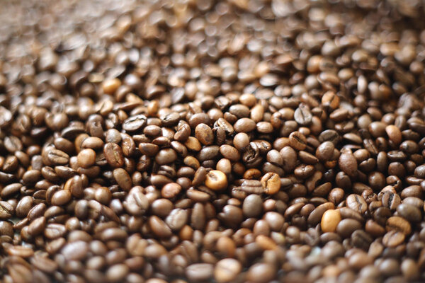 Coffee beans blur testured background. Defocus (or selected focus) coffee texture.