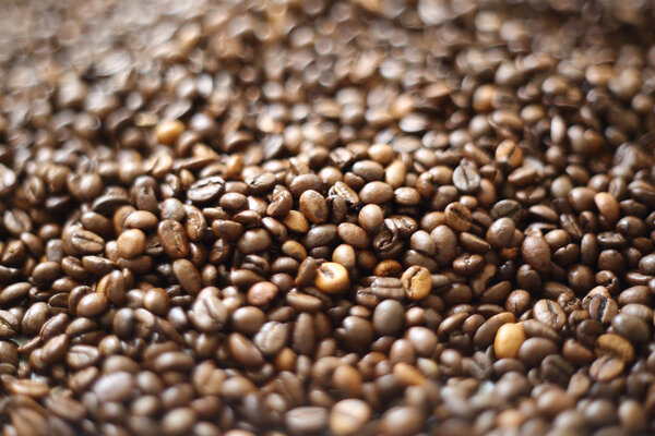 Coffee beans blur testured background. Defocus (or selected focus) coffee texture.