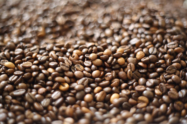 Coffee beans blur testured background. Defocus (or selected focus) coffee texture.