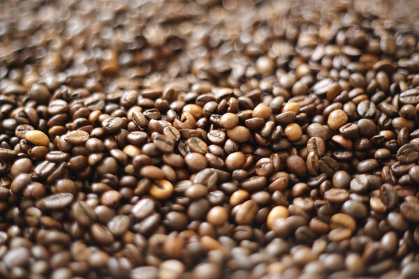 Coffee beans blur testured background. Defocus (or selected focus) coffee texture.