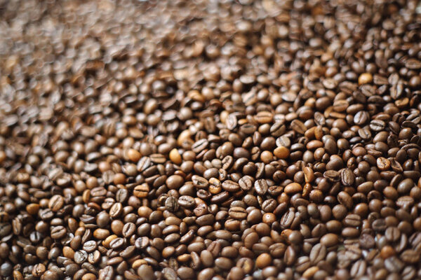 Coffee beans blur testured background. Defocus (or selected focus) coffee texture.