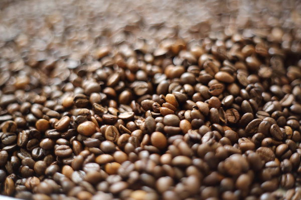 Coffee beans blur testured background. Defocus (or selected focus) coffee texture.