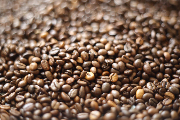 Coffee beans blur testured background. Defocus (or selected focus) coffee texture.