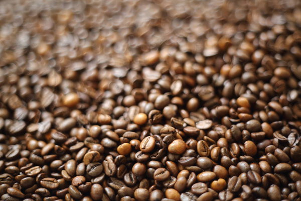 Coffee beans blur testured background. Defocus (or selected focus) coffee texture.