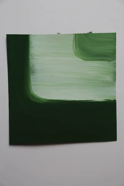 Green and white colors in artwork. Contemporary piece of Art for wall decoration. Gouache and acrylic paints.
