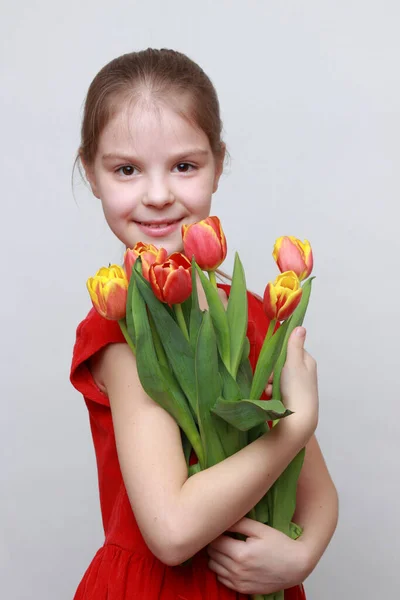 Adorable Little Girl Holding Tulips — Stock Photo, Image