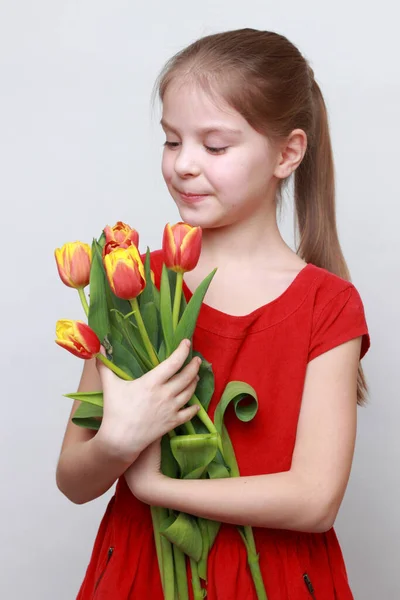 Adorable Little Girl Holding Tulips — Stock Photo, Image