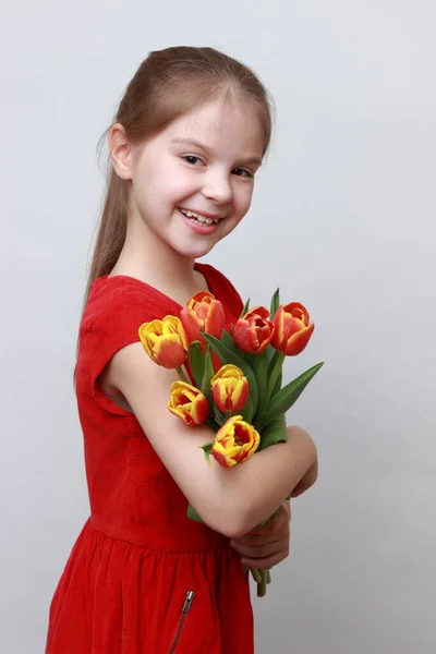 Adorable Little Girl Holding Tulips — Stock Photo, Image
