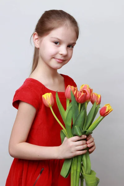 Adorable Niña Sosteniendo Tulipanes Imagen de archivo