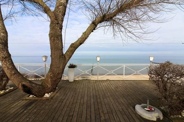 Outdoor seashore restaurant terrace with a beautiful sea horizon view