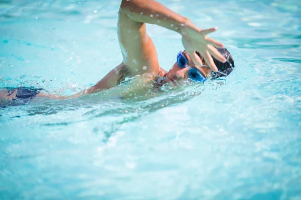 青い水のプールで男の水泳クロール 水泳ゴーグルを身に着けている運動選手の若い男性の三選手の水泳クロールの肖像画 トライアスロンのためのトライアスロントレーニング — ストック写真