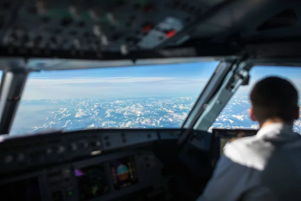 Pilot in  a commercial airliner airplane flight cockpit during flight with great weather