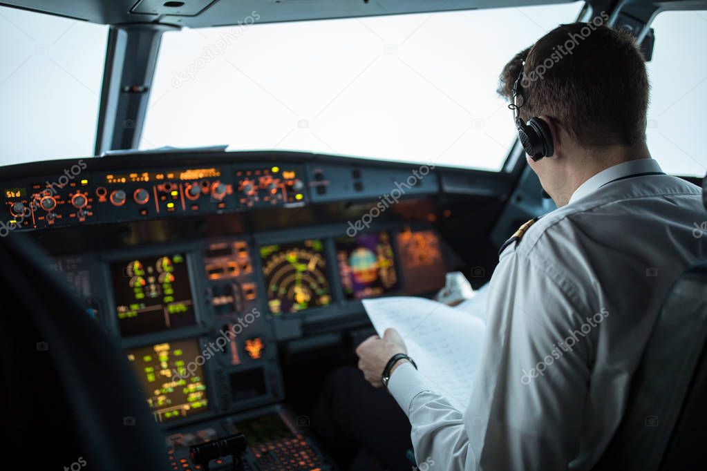 Pilot's hand accelerating on the throttle in  a commercial airliner airplane flight cockpit during takeoff