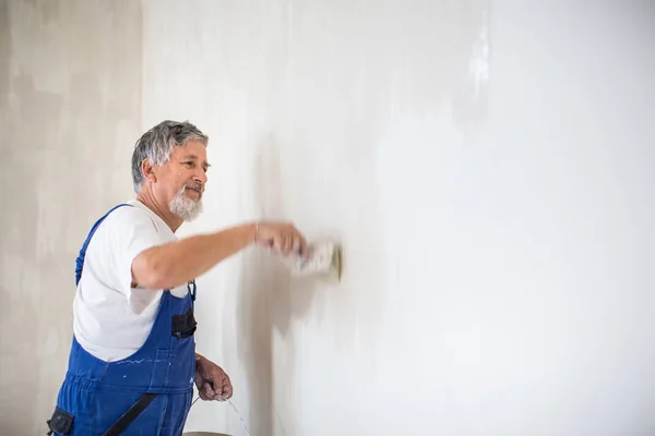 Senior painter man at work with a paint bucket, wall painting concept — Stock Image Senior Painter Man Work Paint Bucket Wall Painting Concept Royalty Free Stock Photos