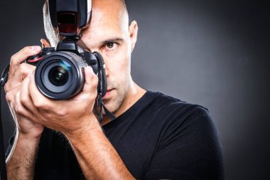 Genç, bir fotoğraf çekimi sırasında stüdyosunda pro erkek fotoğrafçı (Renk tonlu görüntü; sığ Dof)