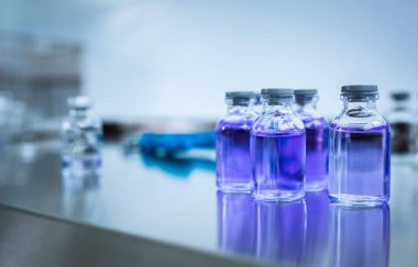 Flasks with liquids in a lab - Pharmaceutical industry factory and production laboratory (color toned image; shallow DOF)