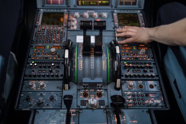 Pilot's hand accelerating on the throttle in  a commercial airliner airplane flight cockpit during takeoff clipart