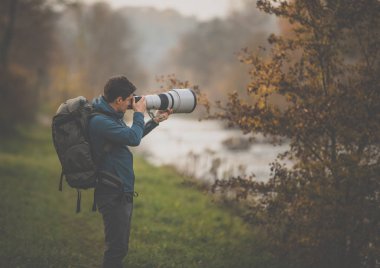 Son sınıf öğrencisi zamanını en sevdiği hobisine harcıyor: Fotoğrafçılık - dijital kamerası / DSLR ve büyük bir telefoto lensi ile dışarıda fotoğraf çekiyor.