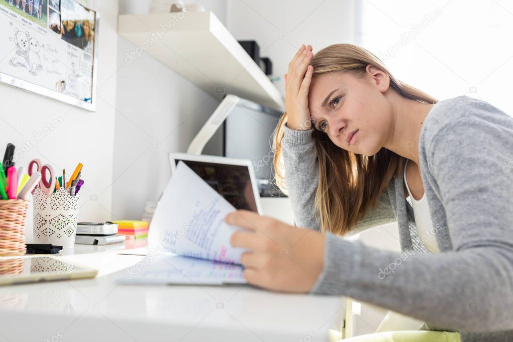 Teenage girl studing for school on a sunny Sunday morning