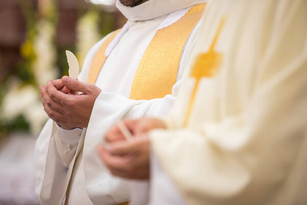 Priest' hands during a wedding ceremony/nuptial mass 