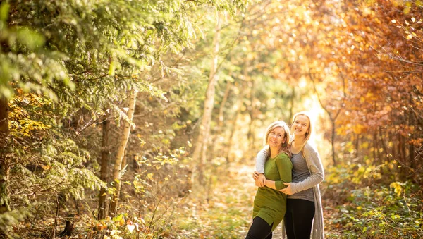 Mother and daughter in beautifiul autumn forest — Stock Photo, Image