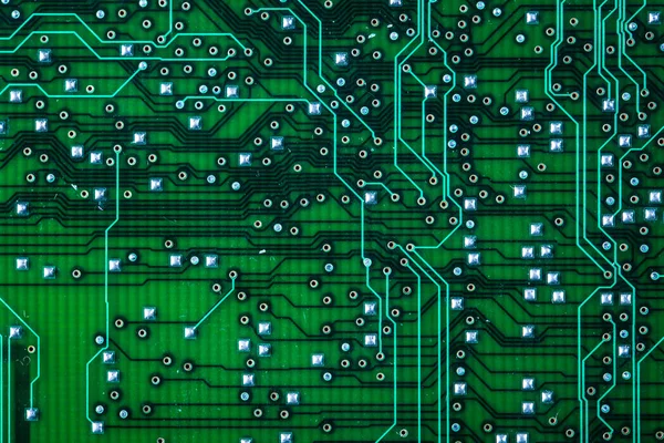 Printed green computer circuit board with many electrical compon — Stock Photo, Image