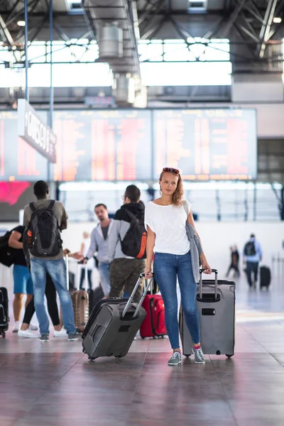 Mujer joven con su equipaje en un aeropuerto internacional — Foto de Stock