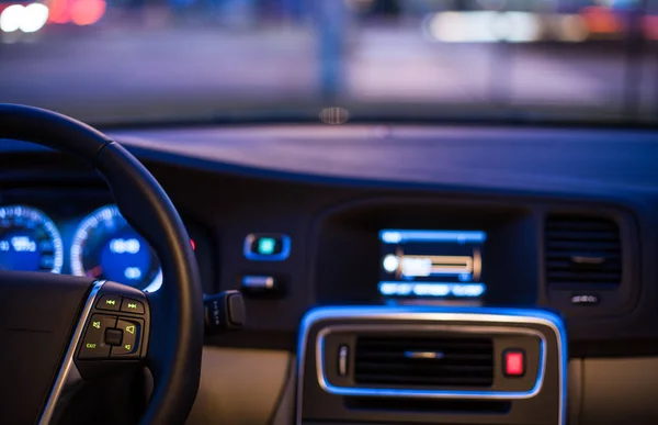 Interior de um carro moderno à noite em uma cidade — Fotografia de Stock