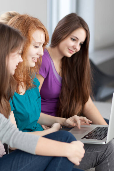 Group of female college students working on their homework