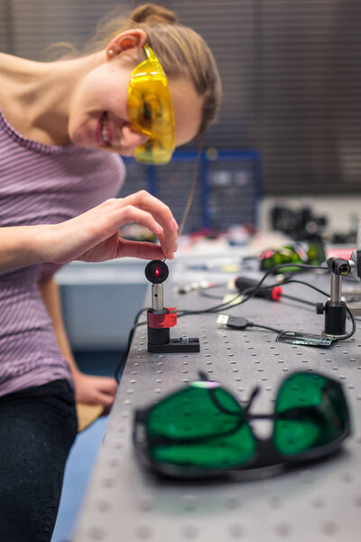 Female scientist carrying out research experiments in a quantum optics lab