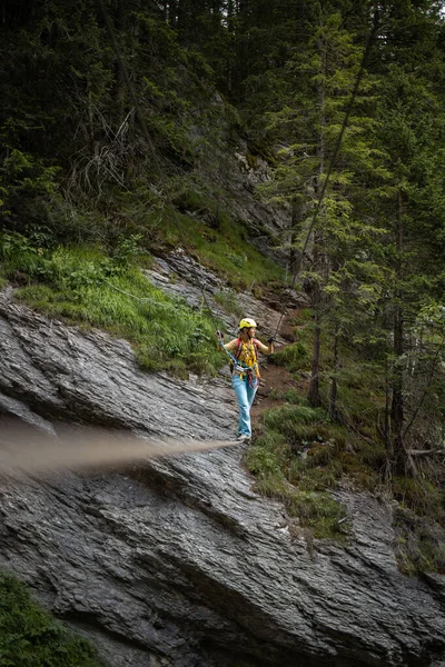 Pretty, female climber on a via ferrata Royalty Free Stock Photos