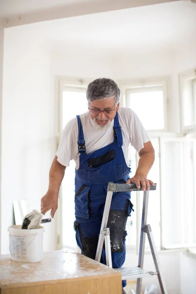 Senior man painting a room white, wall painting concept — Stock Image Senior Man Painting Room White Wall Painting Concept Stock Image