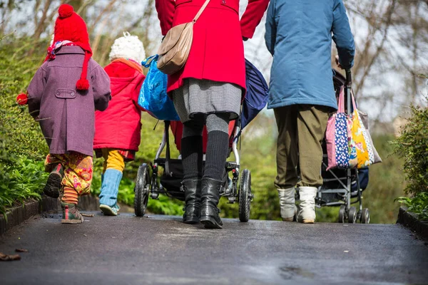 Twee Jonge Moeders Lopen Met Hun Kinderen Een Straat — Stockfoto