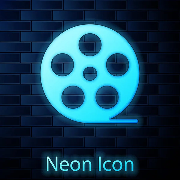 Zářící neon ikona cívky filmu izolované na cihlovou zeď na pozadí. Vektorové ilustrace — Stockový vektor