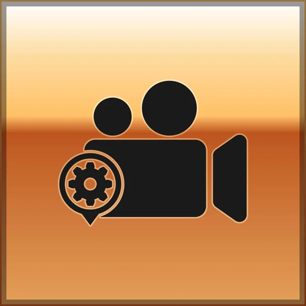 Zwarte film of video camera en tandwielpictogram geïsoleerd op gouden achtergrond. Aanpassen van de app, service concept, instelmogelijkheden, onderhoud, reparatie, vaststelling. Vector illustratie — Stockvector