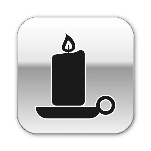 Black Burning candle in candlestick icon isolated on white background. Old fashioned lit candle. Cylindrical aromatic candle stick with burning flame. Silver square button. Vector Illustration — Stock Vector