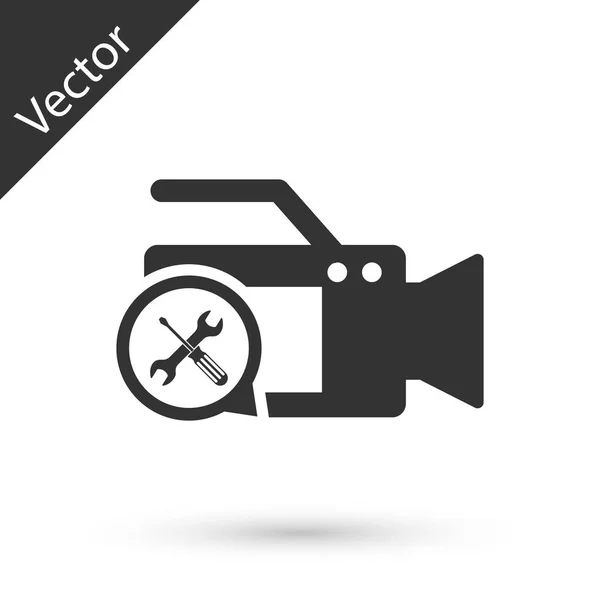 Cámara de vídeo gris con destornillador e icono de llave inglesa aislado en w — Vector de stock