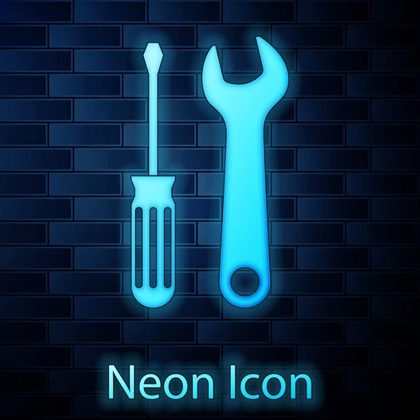 Glowing neon Screwdriver and wrench tools icon isolated on brick wall background. Service tool symbol. Vector Illustration — Stock Vector