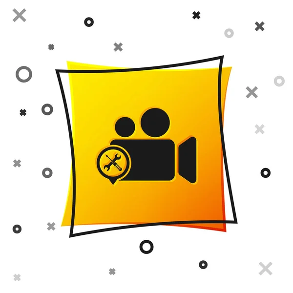 Black Video camera with screwdriver and wrench icon isolated on white background. Adjusting, service, setting, maintenance, repair, fixing. Yellow square button. Vector Illustration — Stock Vector