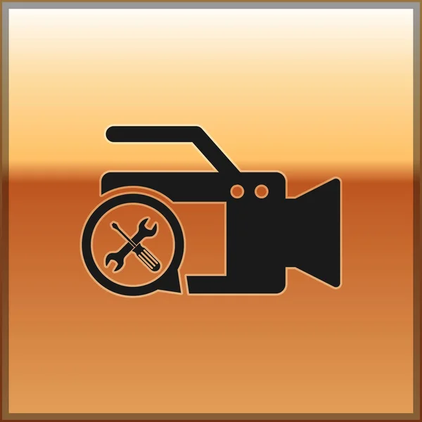 Black Video camera with screwdriver and wrench icon isolated on gold background. Adjusting, service, setting, maintenance, repair, fixing. Vector Illustration — Stock Vector