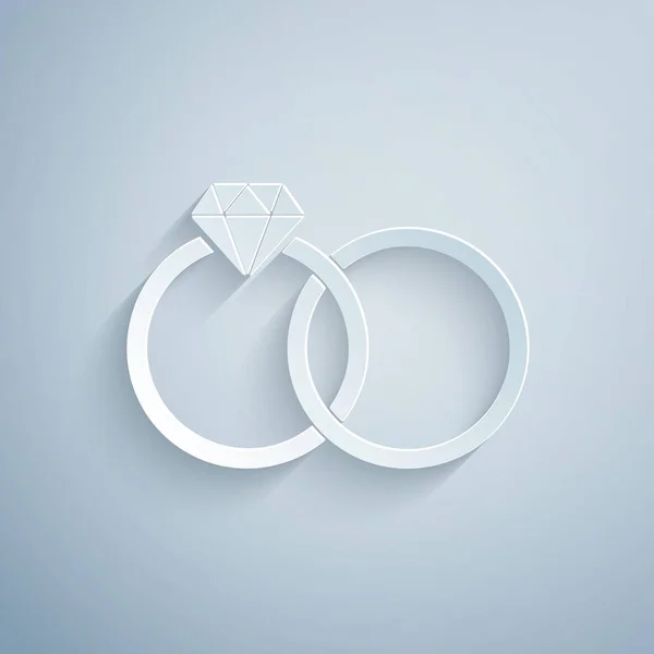 Χαρτί κομμένο εικονίδιο βέρες το οποίο απομονώνεται σε γκρίζο φόντο. Υπογραφή κοσμημάτων νύφης και γαμπρού. Το εικονίδιο του γάμου. Διαμαντένιο δαχτυλίδι. Καλλιτεχνικό στυλ. Απεικόνιση διανυσματικών φορέων — Διανυσματικό Αρχείο