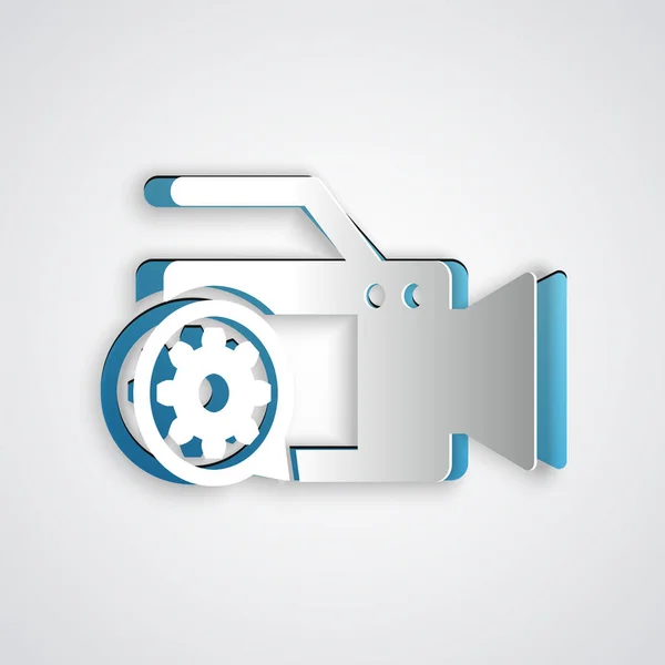 Paper cut Video camera and gear icon isolated on grey background. Adjusting app, service concept, setting options, maintenance, repair, fixing. Paper art style. Vector Illustration — Stock Vector