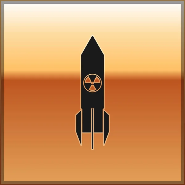 Černá atomová raketová ikona izolovaná na zlatém pozadí. Raketová bomba letí dolů. Vektorová ilustrace — Stockový vektor