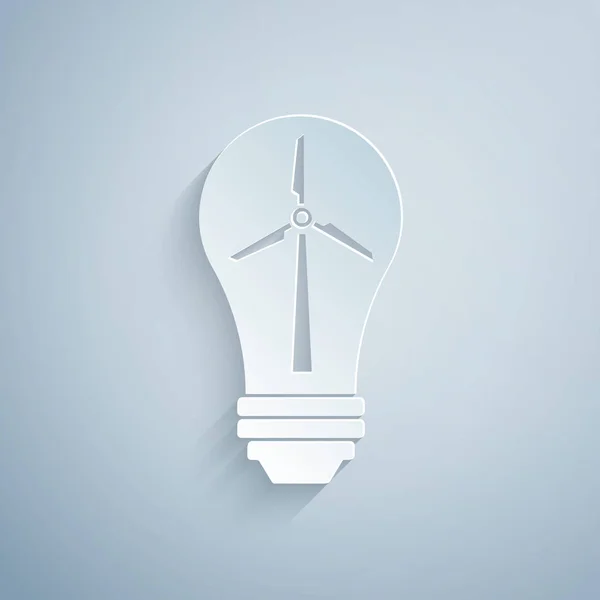 Papel cortado Lâmpada de luz com turbina eólica como ideia de eco amigável fonte de ícone de energia isolado no fundo cinza. Conceito de energia alternativa. Estilo de arte de papel. Ilustração vetorial — Vetor de Stock