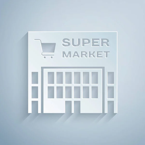 Papier gesneden supermarkt gebouw met winkelwagentje icoon geïsoleerd op grijze achtergrond. Winkel of winkel. Mall Building. Papier kunststijl. Vector illustratie — Stockvector