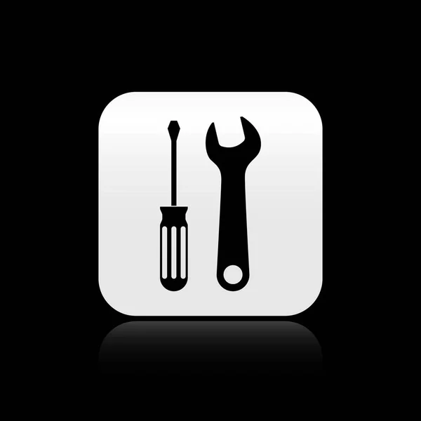 Tournevis noir et icône des outils de clé isolée sur fond noir. Symbole d'outil de service. Bouton carré argenté. Illustration vectorielle — Image vectorielle