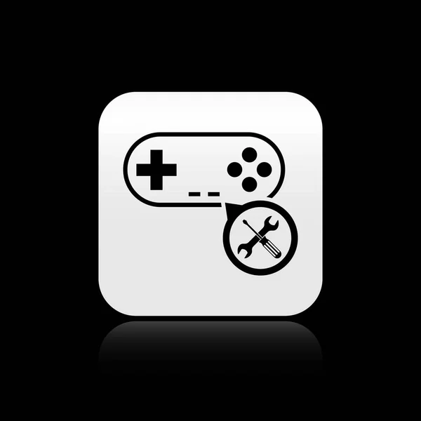 Black Gamepad with screwdriver and wrench icon isolated on black background. Adjusting, service, setting, maintenance, repair, fixing. Silver square button. Vector Illustration — Stock Vector