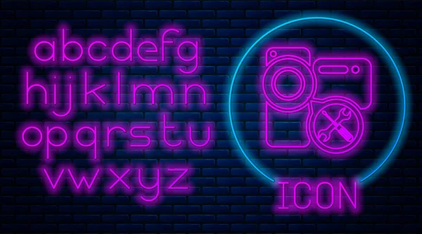 Glowing neon Video camera with screwdriver and wrench icon isolated on brick wall background. Adjusting, service, setting, maintenance, repair, fixing. Neon light alphabet. Vector Illustration — Stock Vector